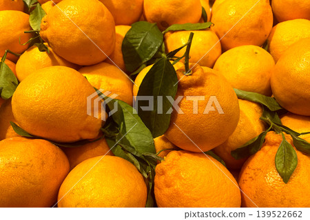 Fresh oranges with green leaves at fruit market Fresh oranges with green leaves at fruit market 139522662
