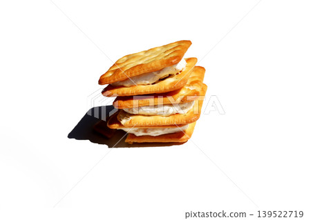 Stack of sandwich crackers filled with creamy filling Stack of sandwich crackers filled with creamy filling 139522719