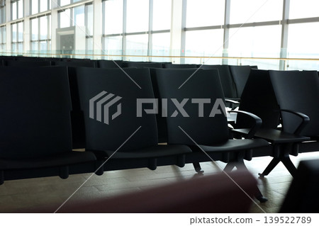 Empty airport waiting chairs near window Empty airport waiting chairs near window 139522789