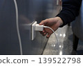 Hand plugging charger into wall socket 139522798