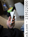 Person holding white smartphone indoors 139522800