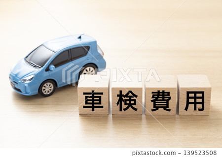 A block with "Vehicle Inspection Fees" written on it and an eco-car A block with "Vehicle Inspection Fees" written on it and an eco-car 139523508