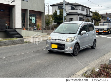 A light passenger car driving on the road A light passenger car driving on the road 139523617