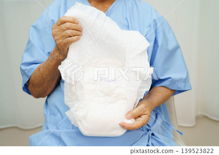 Asian senior woman patient wearing adult incontinence diaper pad in hospital. Asian senior woman patient wearing adult incontinence diaper pad in hospital. 139523822