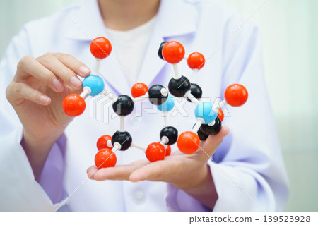Scientist holding molecular model for chemical technology. Scientist holding molecular model for chemical technology. 139523928