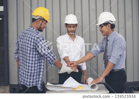 Group of multiracial people Teamwork meeting join hands Engineer Manager Foreman fist bump together. Close up diversity engineer people hands partner teams. Business connection team join partnership Group of multiracial people Teamwork meeting join hands Engineer Manager Foreman fist bump together. Close up diversity engineer people hands partner teams. Business connection team join partnership 139523938