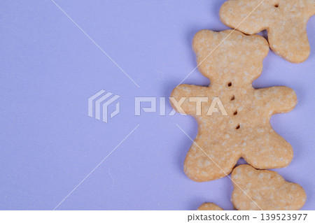 Clean layout showcasing bear cookies on vibrant purple background. Minimalist presentation of bear cookies on purple surface highlighting elegance and simplicity in food styling Clean layout showcasing bear cookies on vibrant purple background. Minimalist presentation of bear cookies on purple surface highlighting elegance and simplicity in food styling 139523977