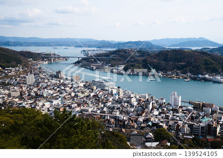 A view of the Onomichi Channel and the port towns of the Seto Inland Sea from Senkoji Park in Onomichi City, Hiroshima Prefecture. A winter landscape with calm seas and mountain ranges. A view of the Onomichi Channel and the port towns of the Seto Inland Sea from Senkoji Park in Onomichi City, Hiroshima Prefecture. A winter landscape with calm seas and mountain ranges. 139524105
