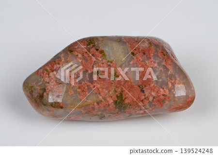 Closeup of polished unakite showing intricate mineral patterns. Highresolution image capturing detailed textures of polished unakite gemstone with colorful mineral inclusions Closeup of polished unakite showing intricate mineral patterns. Highresolution image capturing detailed textures of polished unakite gemstone with colorful mineral inclusions 139524248