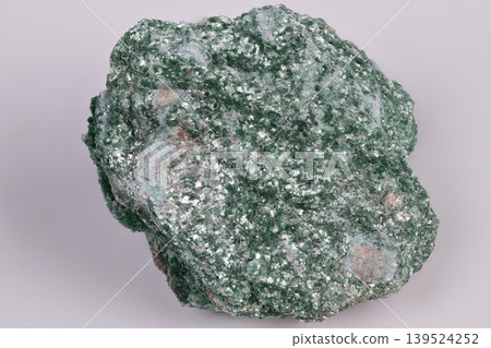 Vivid mineral detail. Highresolution photograph capturing luminous green mineral with glistening mica fragments and tiny surface cavities for educational and artistic purposes 139524252
