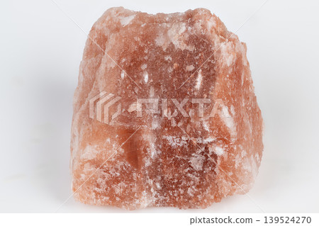 Salt mineral surface. Wellness mineral rock coated with granular coarse salt layers. Pink halite mineral stone displaying rough texture and crystalline salt surface layers 139524270