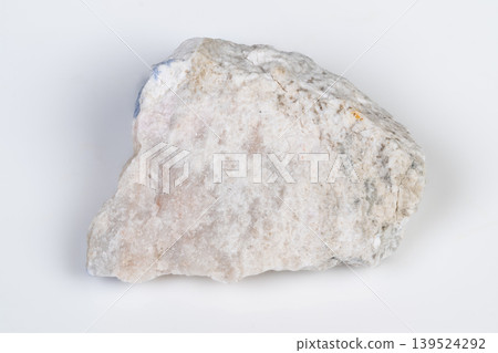 Granular quartz surface on plain background. Photograph of unpolished quartz fragment highlighting subtle texture and refined surface details with neutral backdrop Granular quartz surface on plain background. Photograph of unpolished quartz fragment highlighting subtle texture and refined surface details with neutral backdrop 139524292