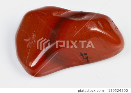 Polished red jasper. Grounding meditation palmstone object. Smooth polished red jasper for spiritual focus. Reflective red jasper palmstone with dark inclusions for grounding Polished red jasper. Grounding meditation palmstone object. Smooth polished red jasper for spiritual focus. Reflective red jasper palmstone with dark inclusions for grounding 139524300