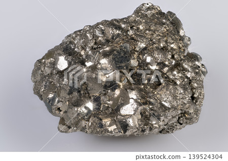 Pyrite nugget display. Clustered iron disulfide crystal with studio lighting effect. Decorative pyrite piece featuring multifaceted cubic crystals for jewelry or interior use Pyrite nugget display. Clustered iron disulfide crystal with studio lighting effect. Decorative pyrite piece featuring multifaceted cubic crystals for jewelry or interior use 139524304