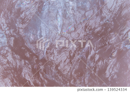 Muted mauve marble wave pattern showing delicate glitter veins and satin sheen across organic mineral surface, minimalist vibe suited for interior and design concept art 139524334