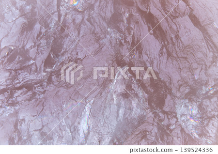 Natural mineral fractures and gentle lighting create calming visual appeal. Smooth rose quartz surface showcasing subtle shimmer and relaxing spainspired atmosphere 139524336