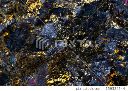 Shimmering gemstone fragments on dark background with gold veins and blue crystals. Glittering mineral pieces with gold veins and cool blue crystals create rich texture 139524344