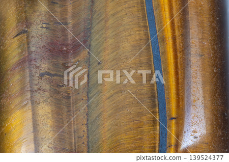 Macro layered rock with blue vein, warm golden strata intersected by cool indigo seam, highdetail surface suited for geology visuals, editorial layouts, and product backdrops Macro layered rock with blue vein, warm golden strata intersected by cool indigo seam, highdetail surface suited for geology visuals, editorial layouts, and product backdrops 139524377