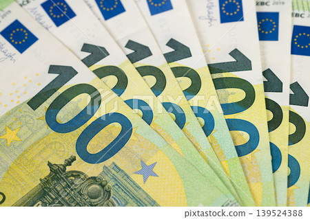 Detailed currency display. Highcontrast shot of euro bills highlighting security features. Closeup of colorful banknotes emphasizing holograms and textured paper surfaces Detailed currency display. Highcontrast shot of euro bills highlighting security features. Closeup of colorful banknotes emphasizing holograms and textured paper surfaces 139524388