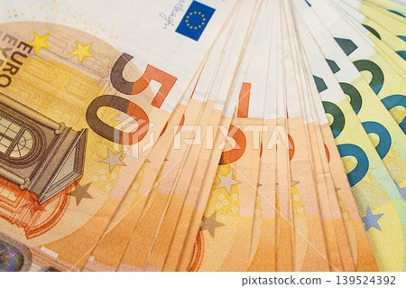 Extreme closeup of euro banknotes texture and microprint, abstract pattern and golden shimmer, detailed security threads and graphic composition for editorial use 139524392