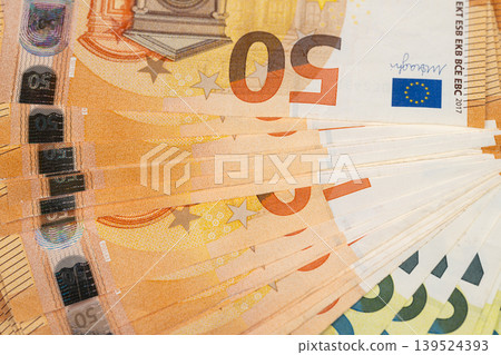 Closeup of tightly stacked euro banknotes suggesting reserve and savings, dense layers show texture and security features, calm lighting conveys safe deposit feel Closeup of tightly stacked euro banknotes suggesting reserve and savings, dense layers show texture and security features, calm lighting conveys safe deposit feel 139524393
