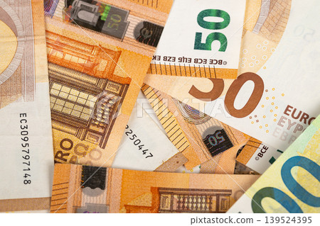Currency notes in different arrangements showing financial exchange flow. Different denominations of euro currency arranged randomly to depict economic transactions and movement Currency notes in different arrangements showing financial exchange flow. Different denominations of euro currency arranged randomly to depict economic transactions and movement 139524395