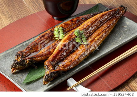 Delicious-looking grilled eel cooked over charcoal. Delicious-looking grilled eel cooked over charcoal. 139524408