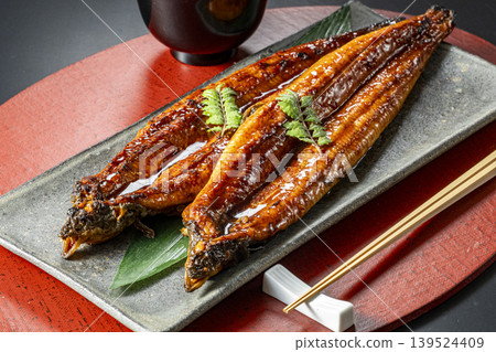 Delicious-looking grilled eel cooked over charcoal. 139524409