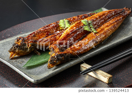Delicious-looking grilled eel cooked over charcoal. Delicious-looking grilled eel cooked over charcoal. 139524413