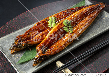 Delicious-looking grilled eel cooked over charcoal. Delicious-looking grilled eel cooked over charcoal. 139524414