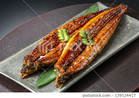 Delicious-looking grilled eel cooked over charcoal. Delicious-looking grilled eel cooked over charcoal. 139524417