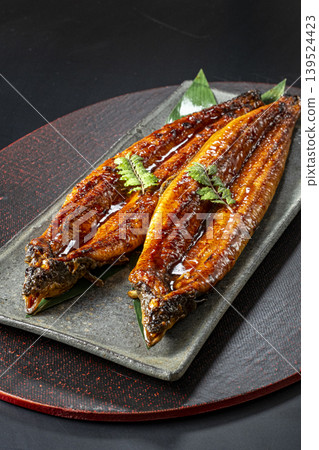 Delicious-looking grilled eel cooked over charcoal. Delicious-looking grilled eel cooked over charcoal. 139524423