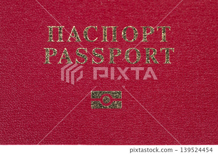Passport showcasing border and travel essence. Red textured cover with biometric icon and emblematic visa area representing international travel and border security Passport showcasing border and travel essence. Red textured cover with biometric icon and emblematic visa area representing international travel and border security 139524454