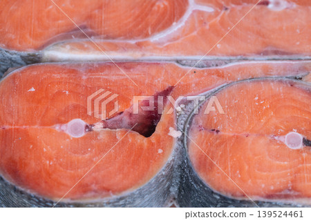 Vivid orange hues showcasing salmon meat and icy details. Artistic depiction of frozen salmon marbling emphasizing bone nodules and crystalline ice patterns for creative use Vivid orange hues showcasing salmon meat and icy details. Artistic depiction of frozen salmon marbling emphasizing bone nodules and crystalline ice patterns for creative use 139524461