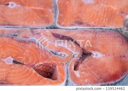 Processing plant frozen salmon cuts arranged for packaging conveyorready portions with frost, quality control and factory production context for food manufacturing visuals 139524462