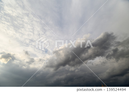 Low storm clouds rolling across sky, dense base and textured upper layers, horizon tension signaling incoming weather, suitable for forecasting and alert visuals Low storm clouds rolling across sky, dense base and textured upper layers, horizon tension signaling incoming weather, suitable for forecasting and alert visuals 139524494