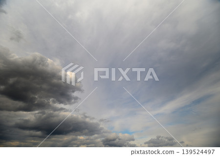 Soft overcast sky layered with clouds, subdued gray tones and gentle gradients create calm, introspective mood suitable for background, meditation, and weather transition imagery 139524497