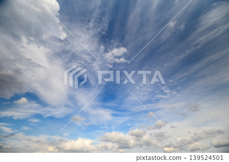 Expansive sky featuring streaked clouds. Vast sky with radiant cloud patterns and converging lines. Dramatic atmospheric display with radiating clouds and perspectiverich horizon Expansive sky featuring streaked clouds. Vast sky with radiant cloud patterns and converging lines. Dramatic atmospheric display with radiating clouds and perspectiverich horizon 139524501