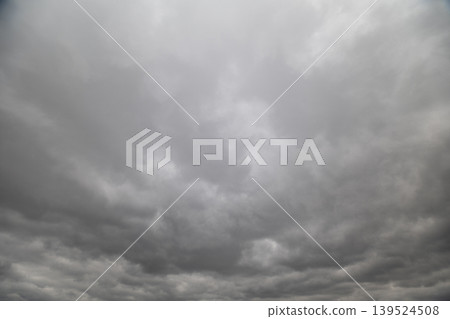 Stormy cloudy sky. Overcast sky with thick storm clouds stirring and gathering tension. Somber sky brimming with heavy clouds signaling approaching storm and unrest 139524508