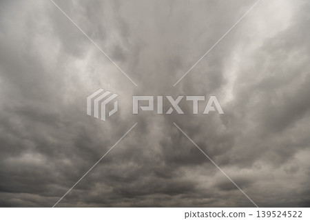 Overcast cloud cover creates neutral background suitable for designs. Consistent grey sky with gentle tonal differences providing minimalist backdrop for various projects Overcast cloud cover creates neutral background suitable for designs. Consistent grey sky with gentle tonal differences providing minimalist backdrop for various projects 139524522