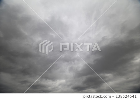 Overcast approach scene. Dim cloudy sky with breaks during airplane landing process. Overcast and layered skies with soft breaks ahead during aircraft descent indication Overcast approach scene. Dim cloudy sky with breaks during airplane landing process. Overcast and layered skies with soft breaks ahead during aircraft descent indication 139524541