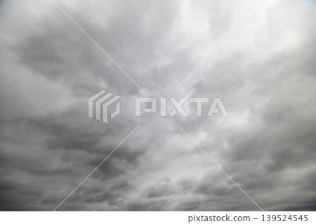Massive cloudy sky with thunderous buildup, deep textured cumulonimbus forms, intense contrast, sense of power and volatility, useful for storm and climate visuals Massive cloudy sky with thunderous buildup, deep textured cumulonimbus forms, intense contrast, sense of power and volatility, useful for storm and climate visuals 139524545