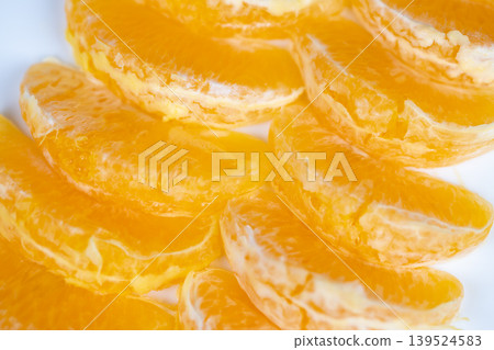 Sweet fruit topping. Glamorous candied orange segments and citrus zest for desserts. Elegant confectionery decoration featuring glazed orange pieces and fragrant zest leaves Sweet fruit topping. Glamorous candied orange segments and citrus zest for desserts. Elegant confectionery decoration featuring glazed orange pieces and fragrant zest leaves 139524583