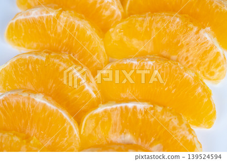 Fresh orange segments evoking summer refreshment and picnic vibe, cool bright tones and hydration suggestion, perfect for beverage or outdoor lifestyle promotions Fresh orange segments evoking summer refreshment and picnic vibe, cool bright tones and hydration suggestion, perfect for beverage or outdoor lifestyle promotions 139524594