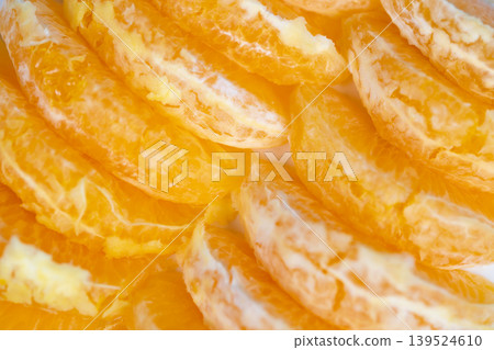 Detailed macro photograph emphasizing orange juice and fibrous tissue. Close examination of vibrant orange segments revealing pulp and succulent juice composition 139524610