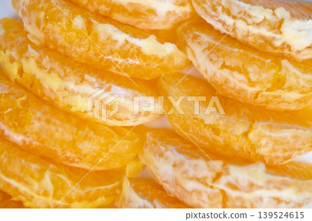 Fresh orange pieces arranged attractively under sunlight. Radiant presentation featuring neatly stacked citrus segments against pristine backdrop illuminated by sunlight Fresh orange pieces arranged attractively under sunlight. Radiant presentation featuring neatly stacked citrus segments against pristine backdrop illuminated by sunlight 139524615