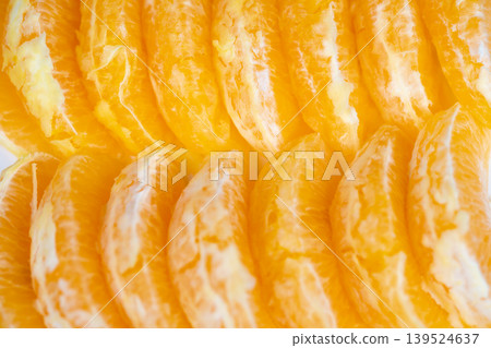 Sharp focus on juicy orange segments with textured pulp. High definition photograph capturing detailed pulp textures and vibrant colors of orange slices against plain background Sharp focus on juicy orange segments with textured pulp. High definition photograph capturing detailed pulp textures and vibrant colors of orange slices against plain background 139524637