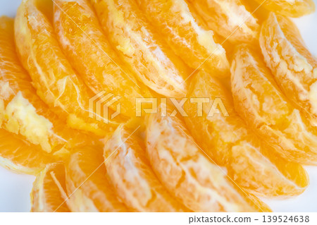 Fresh juicy orange slices arranged for vibrant breakfast scene, glistening pulp, soft white background, natural light accentuating bright color and tempting texture Fresh juicy orange slices arranged for vibrant breakfast scene, glistening pulp, soft white background, natural light accentuating bright color and tempting texture 139524638