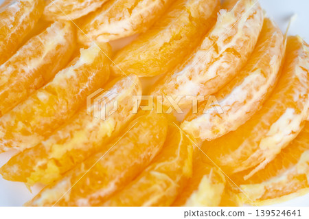 Closeup of peeled oranges showcasing natural textures and seasonal appeal. Image of freshly cut orange segments highlighting organic feel and seasonal freshness Closeup of peeled oranges showcasing natural textures and seasonal appeal. Image of freshly cut orange segments highlighting organic feel and seasonal freshness 139524641