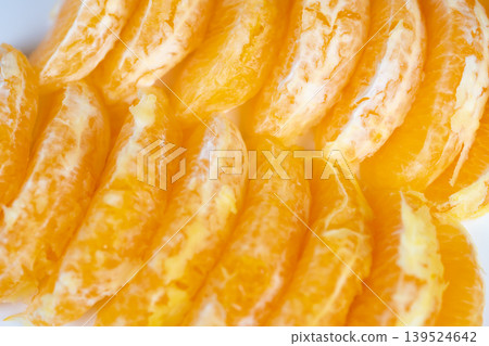 Bright orange slices shine brightly. Luminous juicy segments evoke warm summer feelings. Vivid orange pieces sparkling with sunlight suggest refreshing summer moments Bright orange slices shine brightly. Luminous juicy segments evoke warm summer feelings. Vivid orange pieces sparkling with sunlight suggest refreshing summer moments 139524642